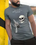 Sarcastic Good Luck Whatever Skeleton Drinking Graphic Tee - model wearing grey tee, leaning on column