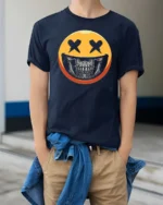Striking Yellow Smiley Face Skull Mask Graphic Tee - model wearing navy tee with hands in pockets
