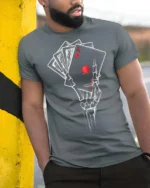 Awesome Royal Flush Grinning Boneyard Casino Soft Tshirt - model wearing grey tee, leaning on column