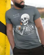 Sarcastic Last Time I Gave A Fuck Skeleton Graphic Tee - model wearing grey tee, leaning on column