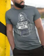 Entertaining Sorry I Missed Warm Ups Skeleton Graphic Tee - model wearing grey tee, leaning on column