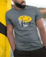 Skeleton Peeking From Manhole Smiley Face Mask Tshirt - model wearing grey tee, leaning on column