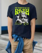 Dazzling Born To Be Rich Crowned Baby Graphic Tshirt - model wearing navy tee with hands in pockets