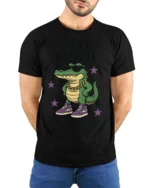 Cool Crocodile Wearing Sneakers Stay Weird Graphic Tee - model wearing black tee with hands behind back