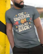 Charming Retro Planet The Universe Has My Back Graphic Tee - model wearing grey tee, leaning on column