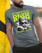 Dazzling Born To Be Rich Crowned Baby Graphic Tshirt - model wearing grey tee, leaning on column