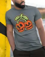 Eccentric Groovy Skull Cherry Halloween Novelty Graphic Tee - model wearing grey tee, leaning on column