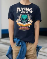 Thrilling Flying With Me Teal Alien Spaceship Tshirt - model wearing navy tee with hands in pockets