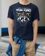 Nocturnal Trash King Raccoon Crown Luxury Graphic Tee - model wearing navy tee with hands in pockets