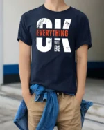 Motivating OK Everything Will Be OK Text Graphic Tshirt - model wearing navy tee with hands in pockets