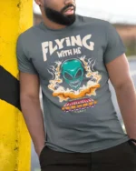 Thrilling Flying With Me Teal Alien Spaceship Tshirt - model wearing grey tee, leaning on column