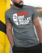Thought Provoking Ideas Are Bullet Proof Anonymous Tshirt - model wearing grey tee, leaning on column