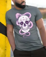 Charming Pastel Sugar Skull Floral Serpent Graphic Tee - model wearing grey tee, leaning on column