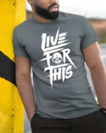 Rugged Live For This Military Skull Helmet Graphic Tee - model wearing grey tee, leaning on column