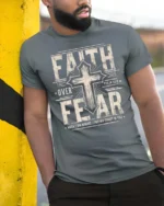 Inspiring Faith Over Fear Psalm Bible Verse Graphic Tee - model wearing grey tee, leaning on column