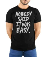 Striking Nobody Said It Was Easy Grit Motivation Graphic Tee - model wearing black tee with hands behind back