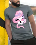 Alluring Pastel Sugar Skull Pink Serpent Graphic Tee - model wearing grey tee, leaning on column